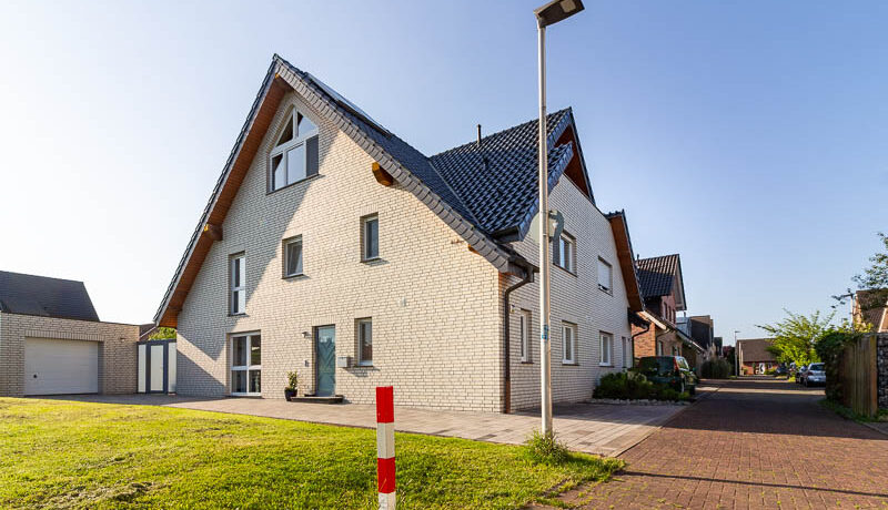 Repräsentative Doppelhaushälfte in moderner Klinkeroptik mit großer Einfahrt, Garage und gepflegtem Vorgarten – ein Zuhause mit Charakter.