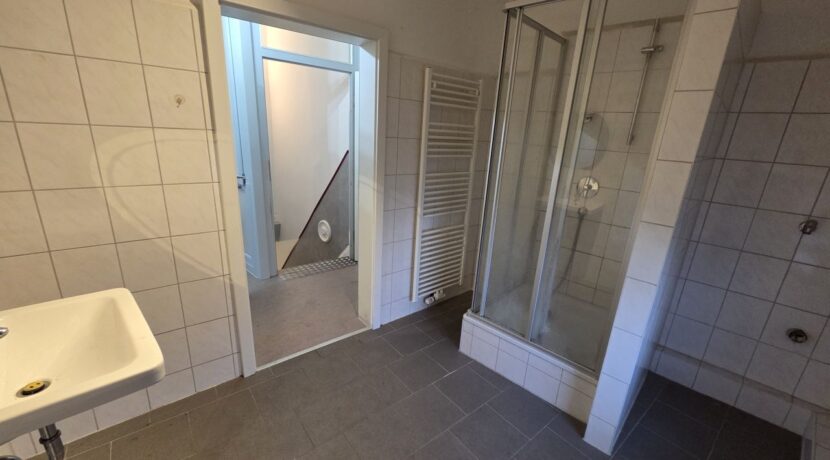 Badezimmer mit Sicht auf Dusche und Flur im OG